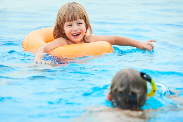 Adorable boy swimming in the pool