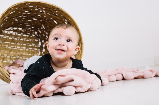 Adorable child in overturned basket