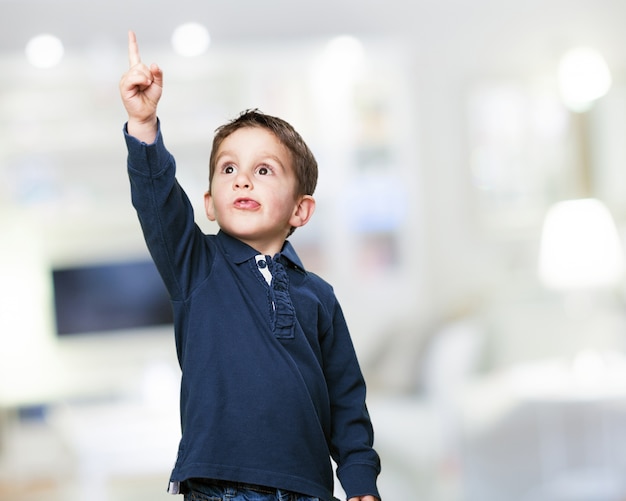 Adorable child pointing upwards