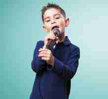 Free photo adorable child singing with a microphone