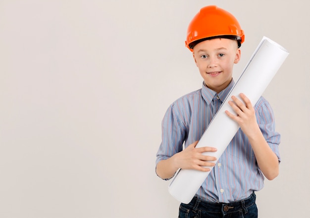 Adorable construction worker holding project