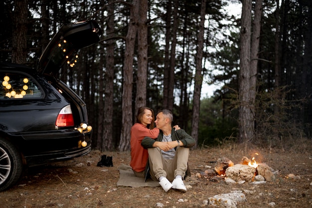 Adorable couple enjoying bonfire