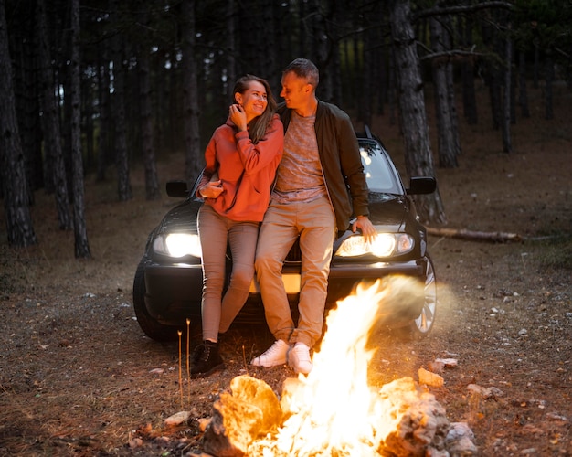 Free photo adorable couple enjoying bonfire