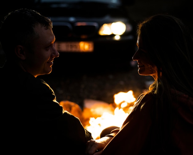 Adorable couple enjoying bonfire