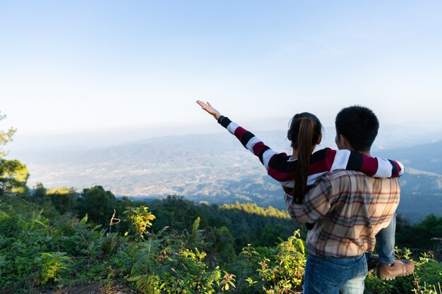 Adorable couple on a sunny day in nature on hill