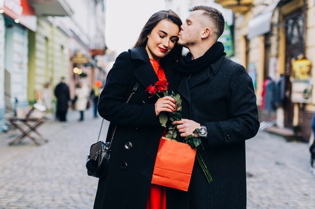Adorable couple with gifts outside