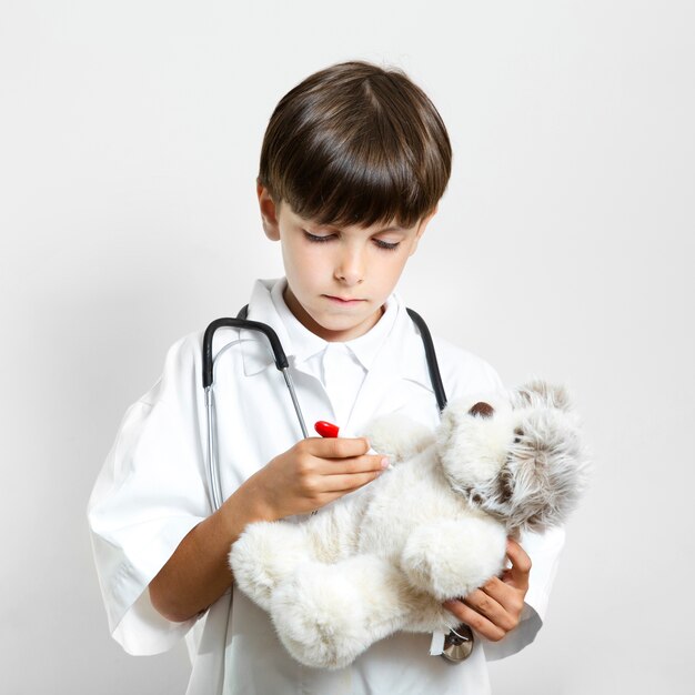 Adorable cute boy holding a teddy bear