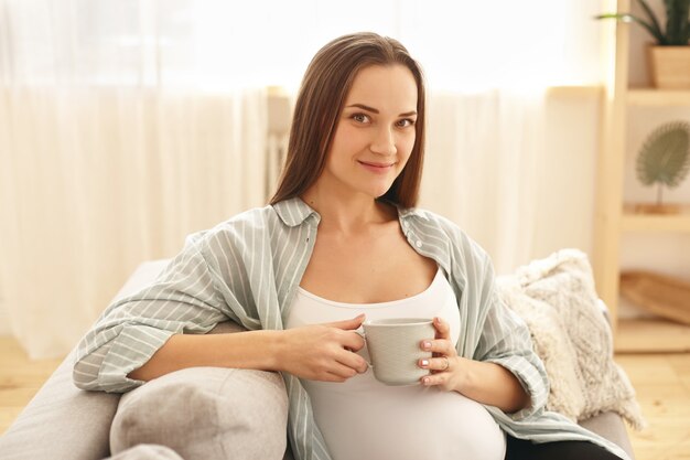 Adorable cute young pregnant woman posing