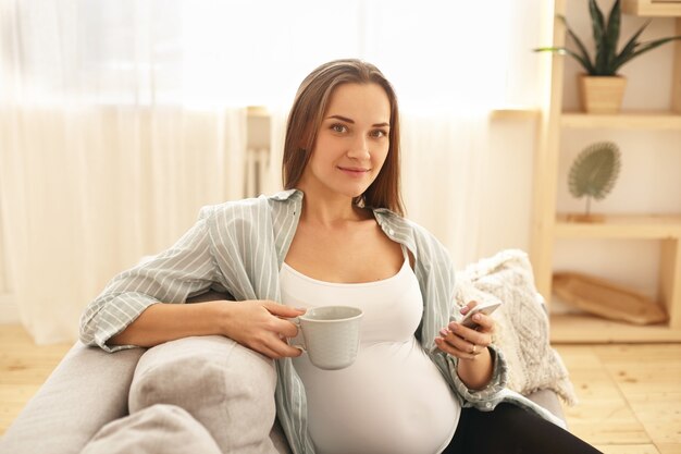 Adorable cute young pregnant woman posing