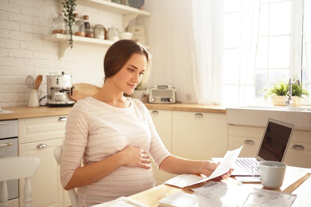 Adorable cute young pregnant woman posing