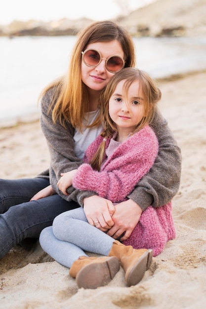 Adorable daughter and mother posing