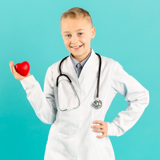 Free photo adorable doctor holding heart front view