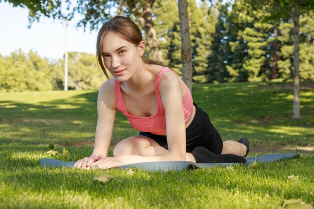 Adorable girl closed her eyes and sitting at the park