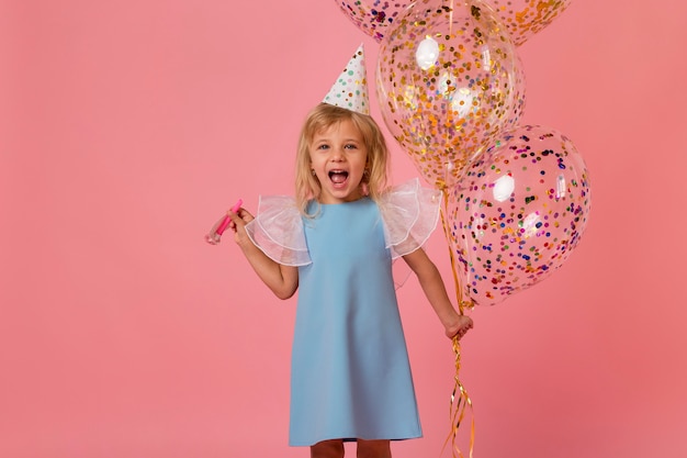 Free photo adorable girl in costume with balloons