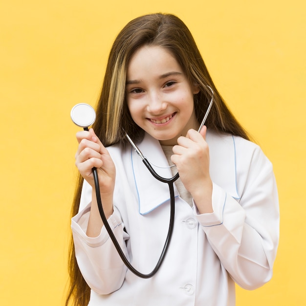 Adorable girl holding stethoscope