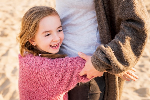 Adorable girl hugging mother medium shot