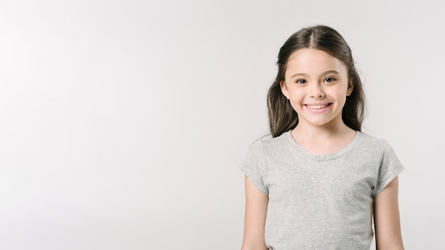 Adorable girl standing in studio