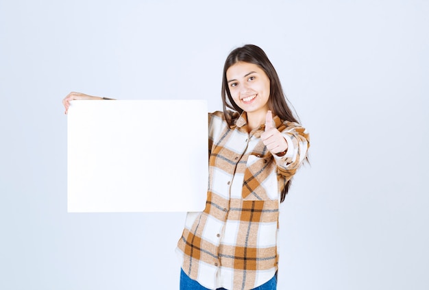  adorable girl with white big blank giving thumbs up. 