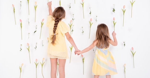 Adorable girls pointing at tulips