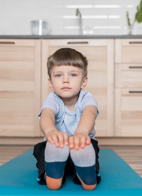 Free photo adorable kid training at home