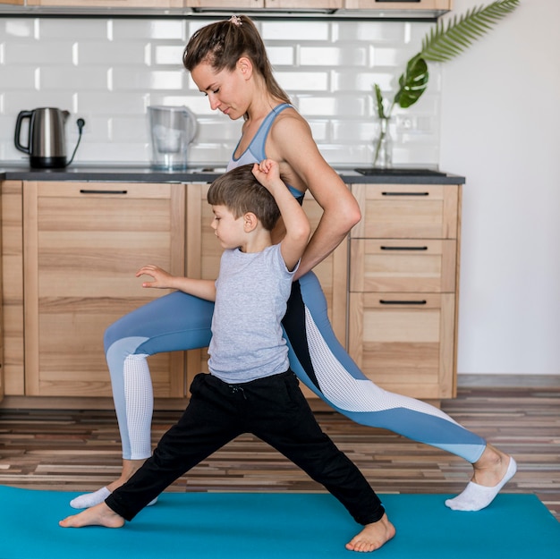 Adorable kid training together with mom