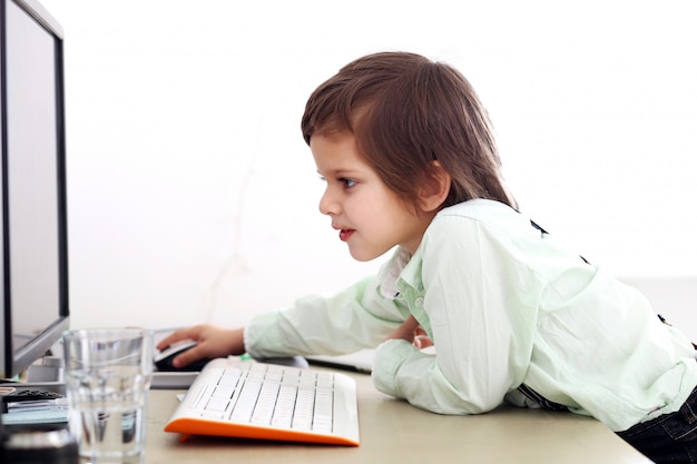 Adorable kid using a computer