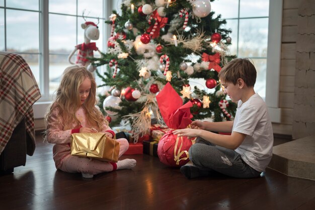 クリスマスの日を楽しんでいる愛らしい子供たち