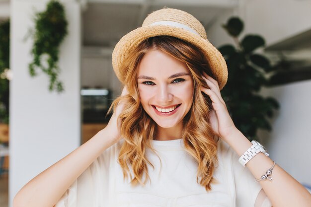 Adorable laughing girl wearing silver bracelet and white wristwatch posing