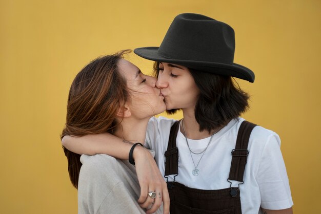 Adorable lesbian couple kissing outdoors