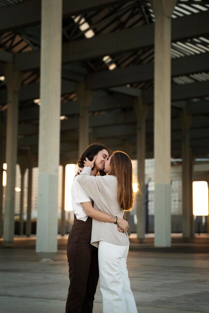 Adorable lesbian couple kissing outdoors