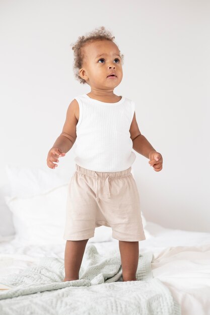 Adorable little black baby girl at home