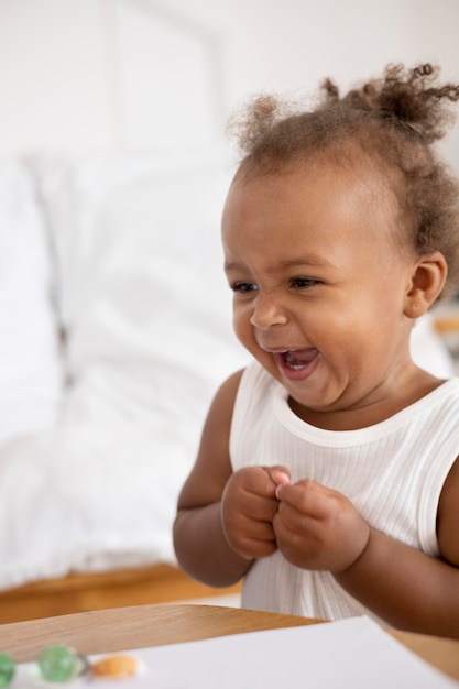 Free photo adorable little black baby girl at home