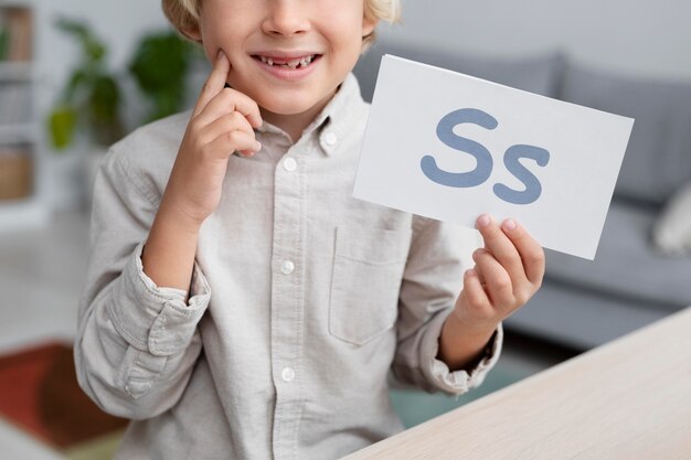 Adorable little boy doing an online session of speech therapy
