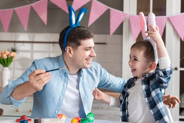 Adorable little boy playing with father