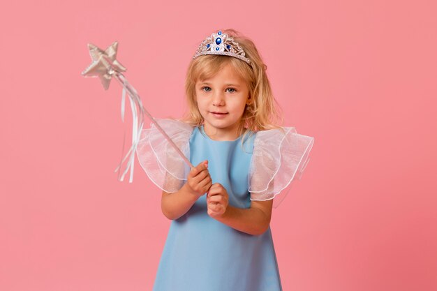 Adorable little girl in costume and wand