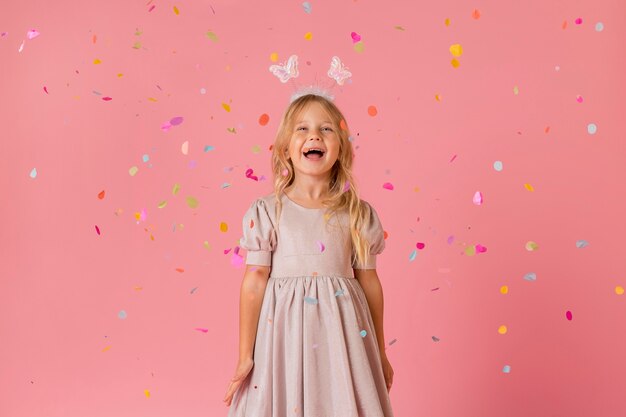 Adorable little girl in costume with confetti
