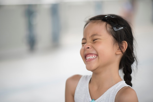 Adorable little girl laughing in the street