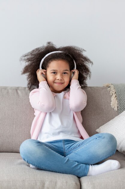 Adorable little girl listening to music