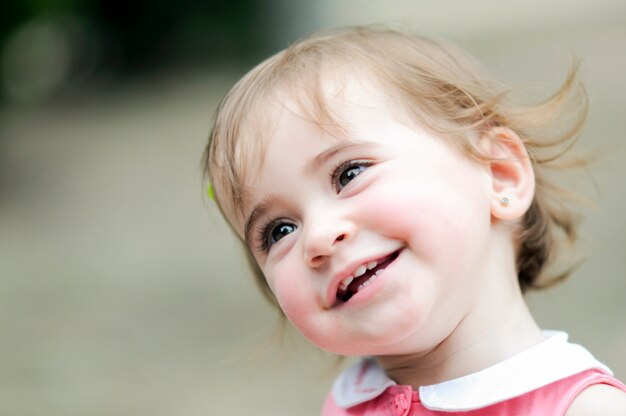 Adorable little girl playing in a urban park