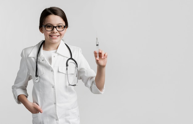 Adorable little girl posing as doctor