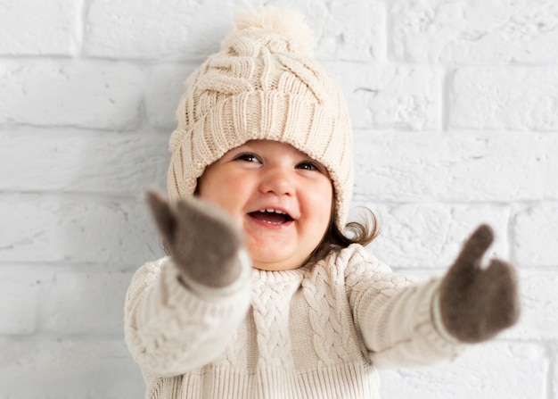 Adorable little girl raising her hands