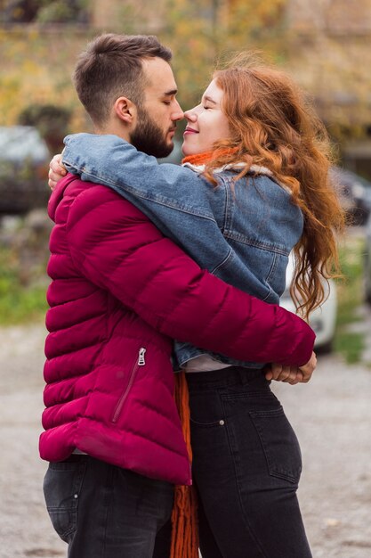 Adorable man and woman hugging