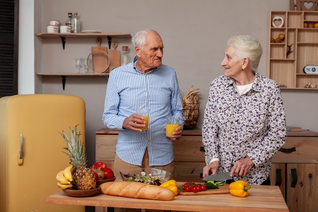 Adorable mature man and woman in the kitchen