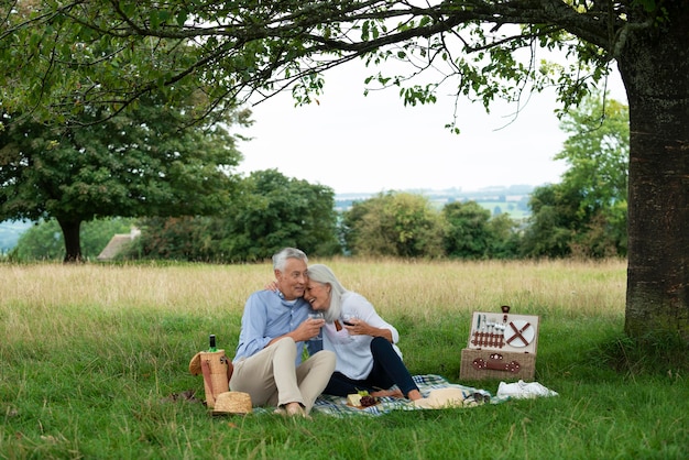 Adorable senior couple having a picnic outdoors