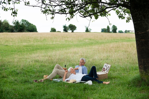 Adorable senior couple having a picnic outdoors