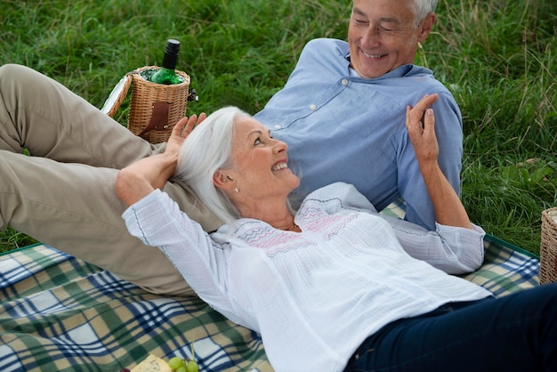 Adorable senior couple having a picnic outdoors