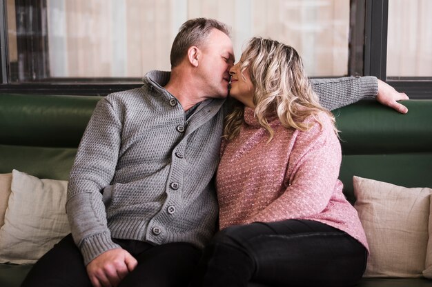 Adorable senior couple kissing front view