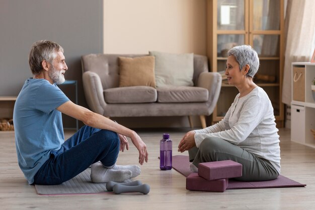 Adorable senior couple training at home