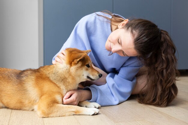 Adorable shiba inu with its female owner