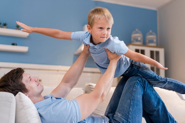 Free photo adorable son playing with his father